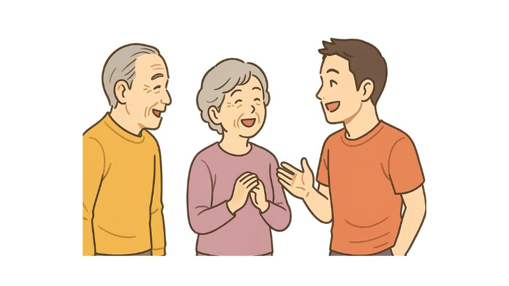 男性指導員と高齢者夫婦が微笑みながら会話をしている